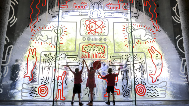 Ferny Creek Primary School students, from left, Archie, Maeve and Reuben check out the recreated mural.