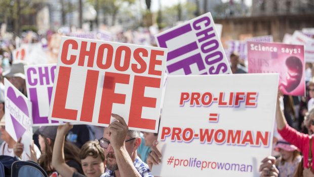 Protesters hold placards during a pro-life rally in Brisbane on Saturday.