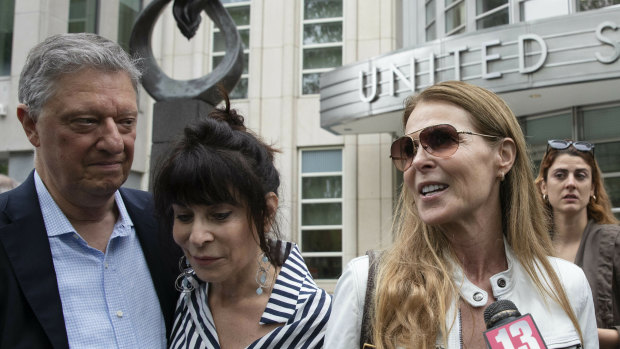 Toni Natalie, second from left, and Catherine Oxenberg talk with the media outside Brooklyn federal court after nxivm defendant Keith Raniere was found guilty on all counts in New York. Natalie is a former member and Oxenberg's daughter was a member of the group. 