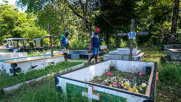 Kabai and Pabai at the Saibai cemetery, which has had graves and remains washed away in king tides.