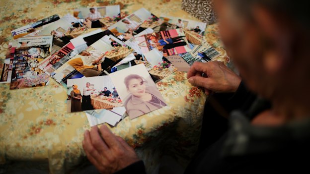 Muhammad Abdullah with a photo of his missing fiancee Nursa Mehmetjan.