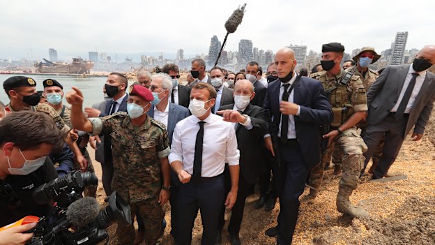 French President Emmanuel Macron inspects the site of the August 4 blast in Beirut.