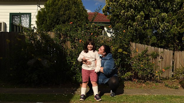 Fairfield resident Maria Moschetti embraces her 6-year-old daughter Lily Thomson, who has autism. They’ve been trying to bring joy to their neighbours where they can.