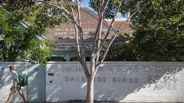 Graffiti on a house next to the school calling for the headmaster and council to resign.