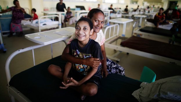 Sylvester Begama, 13, with his mother Theresa Nata.