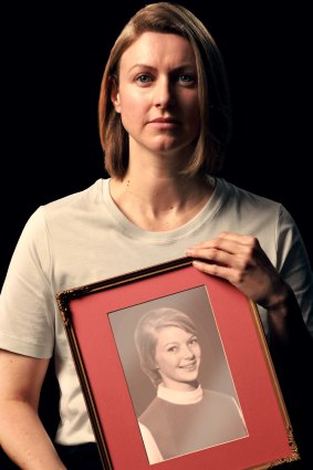 Kathryn Joy holds an image of their mother, who was killed in the family home by Joy’s father.