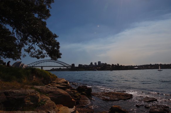 Smoke from Hazard reduction work in northern Sydney drifts across the harbour from Mrs Macquarie’s Chair.