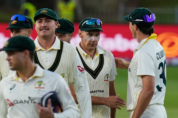 Australia’s Scott Boland, second from right, is congratulated by captain Pat Cummins.