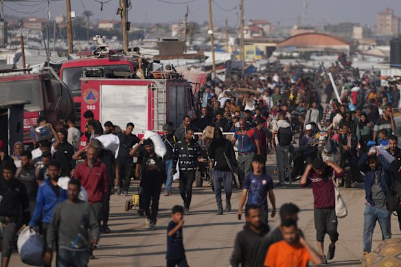 Palestinians carry aid packages from the Gaza Humanitarian Foundation in Khan Younis on Sunday.