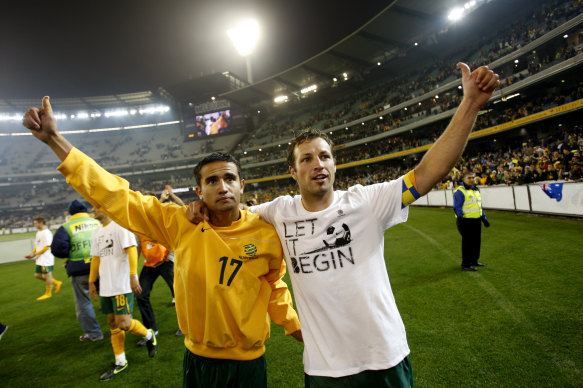 Lucas Neill, right, and Tim Cahill salute the crowd after beating Japan in a World Cup qualifier at the MCG in 2009.