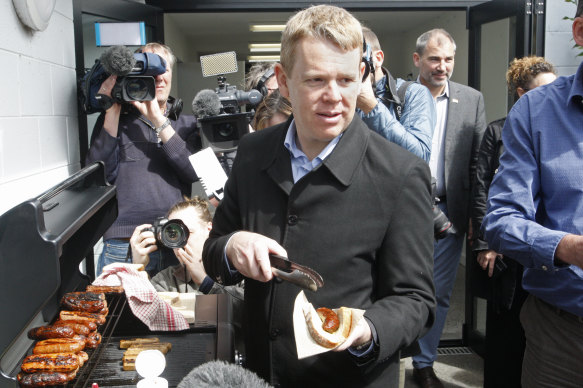 Democracy sausage: NZ PM Chris Hipkins hands food on Monday.