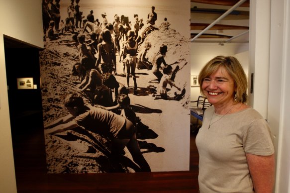 Northern Beaches Council library historian Michelle Richmond with a photo from the library's exhibition showing highlights from the Sydney Morning Herald archives. 