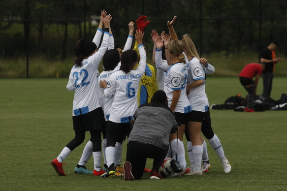 Sydney celebrate with a cheer in their huddle.