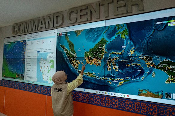 The locations of fires burning this month across Borneo and elsewhere in Indonesia, as seen on a screen at the command center of the Regional Disaster Management Agency in Pontianak.