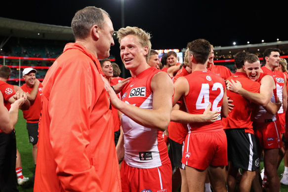 John Longmire, Senior Coach of the Swans and Isaac Heeney of the Swans celebrate.