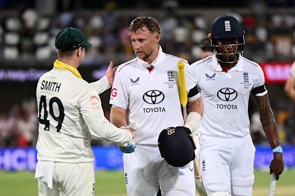 Steve Smith shakes congratulates century-maker Joe Root at stumps on day one.