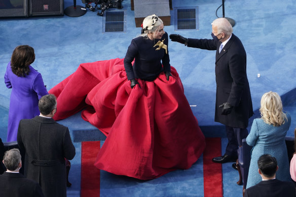 President Joe Biden greets Lady Gaga, who performed the national anthem.