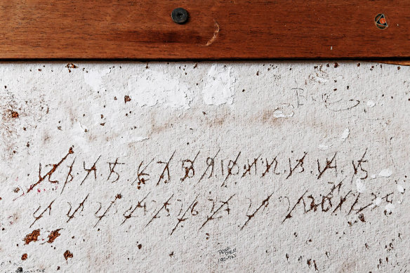Inside one of the cells at Pentridge, where an inmate has scratched into a writing board the number of months or years he has left to serve.