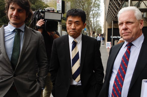 Valentine Yee leaves the ICAC on Monday flanked by his legal team.