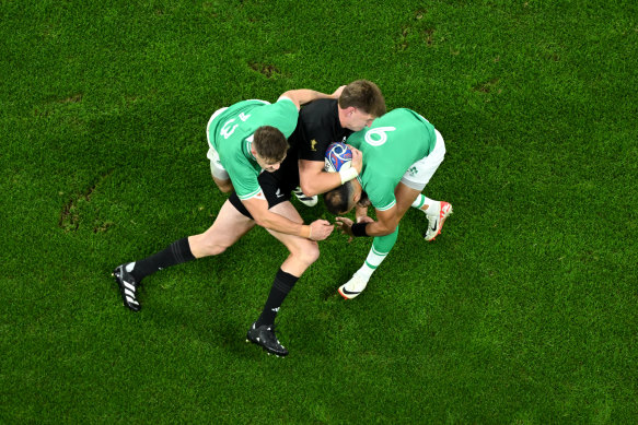 Jordie Barrett of New Zealand is tackled by Garry Ringrose and Jamison Gibson-Park of Ireland.