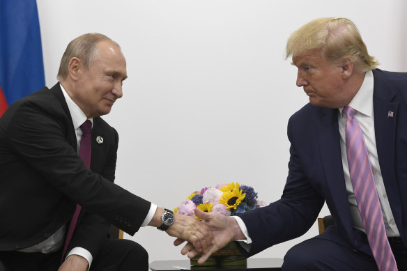 Donald Trump, right, shakes hands with Russian President Vladimir Putin, left, during a bilateral meeting on the sidelines of the G20 summit in Osaka, Japan in 2019.