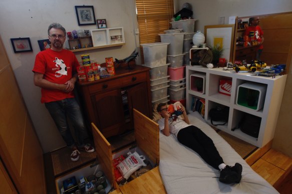 Mark Jordan in his son Bill's bedroom, where he has built a pantry cupboard into a false floor.