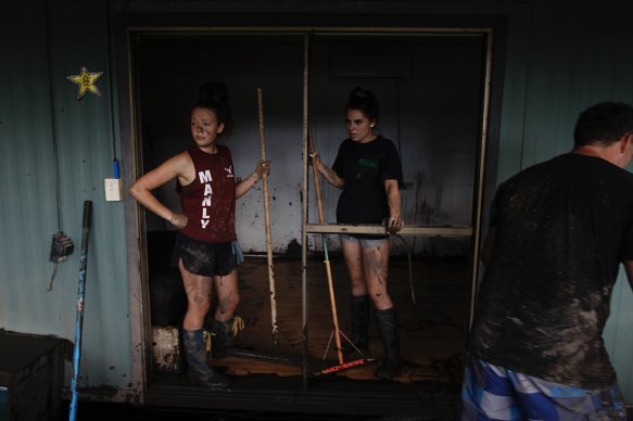 Zahra Kell and her cousin Mischa survey the flood damage at Wisemans Ferry on Sunday.