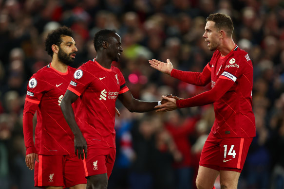 Sadio Mane (centre) celebrates scoring Liverpool’s third with Mohamed Salah and Jordan Henderson.