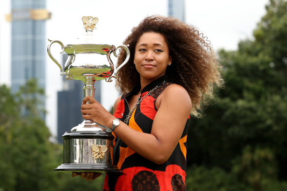 Naomi Osaka poses with the trophy the day after winning her second Australian Open title and fourth grand slam crown.