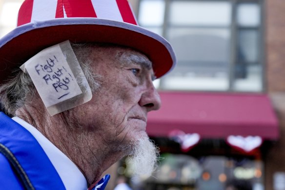 A supporter, donning an ear bandage in solidarity with former president Donald Trump.