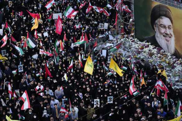 Mourners attend a rally commemorating slain Hezbollah leader Hassan Nasrallah, shown in billboard, at Felestin (Palestine) Sq. in downtown Tehran, Iran.