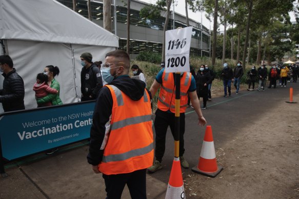 People queue at the Sydney Olympic Park vaccination hub.