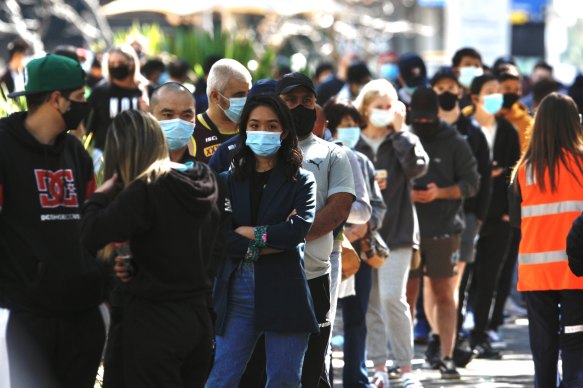 People line up to be vaccinated at the Sydney Olympic Park hub.  