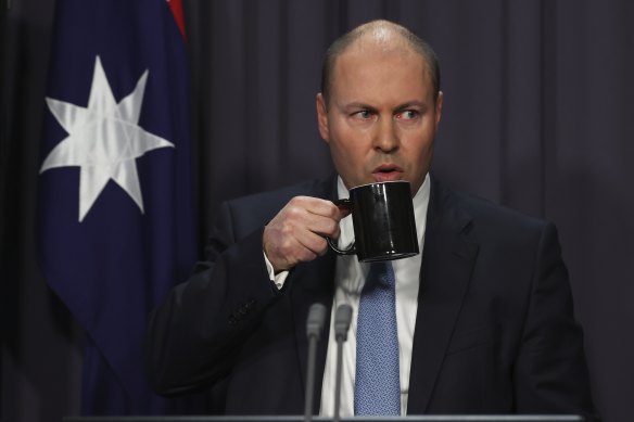 The Treasurer takes a sip during his press conference. 