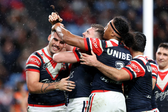 The Roosters celebrate Terrell May’s try.