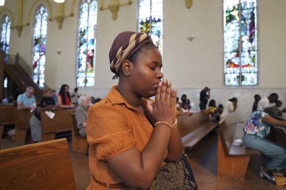 Marie Morette, a congregant of St Raphael Catholic Church, prays during mass in Springfield.