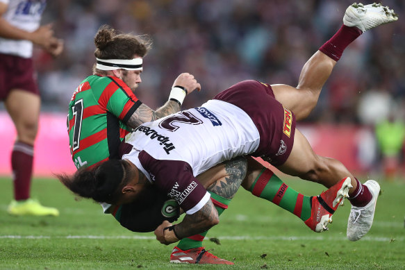 Ethan Lowe is tackled by Manly’s Jorge Taufua during a match for the Rabbitohs in 2019.