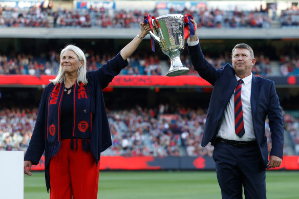 High point: Melbourne president Kate Roffey and CEO Gary Pert show off the premiership cup at the MCG in March.