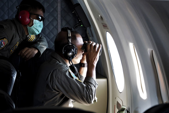 Indonesian navy crew members look over Indonesian waters. 