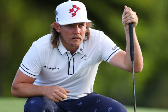 Cameron Smith of Australia lines up a putt on the 18th green during the first round of the 2024 Masters.