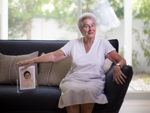 Holocaust survivor Nina Bassat, with a photograph of herself as a baby in 1939.