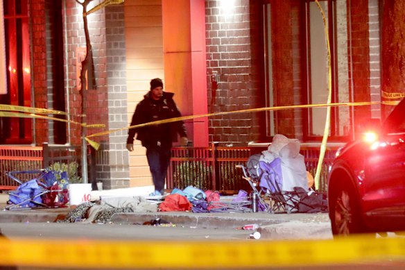 Police investigate the scene of the crash involving multiple people and injuries at a holiday parade in Waukesha, Wisconsin. 