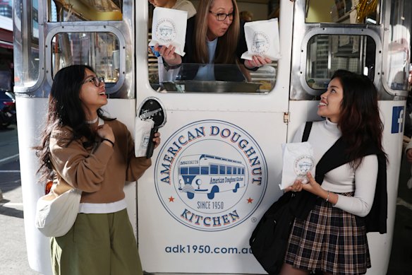 Belinda Donaghey, owner of the American Doughnut Kitchen, with customers Rhyanna Zaharom (left) and Mia Rahimi. 