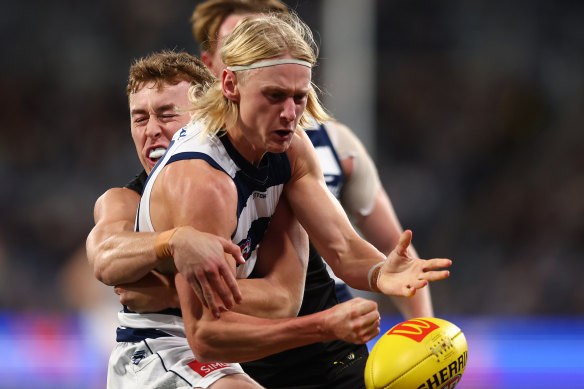 Oliver Dempsey of the Cats is tackled.