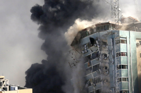 The building housing the offices of the AP and other media in Gaza City collapses after it was hit by an Israeli airstrike. 