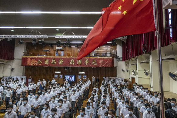 Students stand during a flag-raising ceremony for National Security Education Day at a secondary school in Hong Kong, the first such occasion since the introduction of new national security laws which followed months of pro-democracy protests.