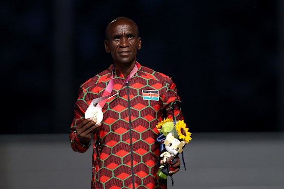 Eliud Kipchoge poses with his gold medal at the Tokyo Olympics.