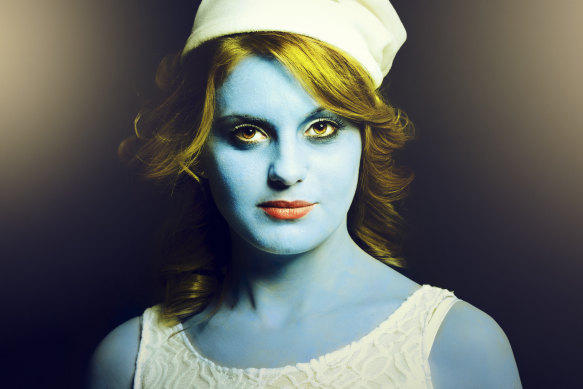 A young woman as a Smurf, the small blue species that helped to define an Australian childhood. 
