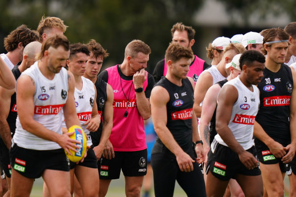 Collingwood coach Nathan Buckley (centre) with his players at training on Wednesday.