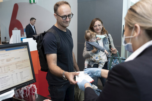 Passengers check-in for their flight to Adelaide on Thursday. 